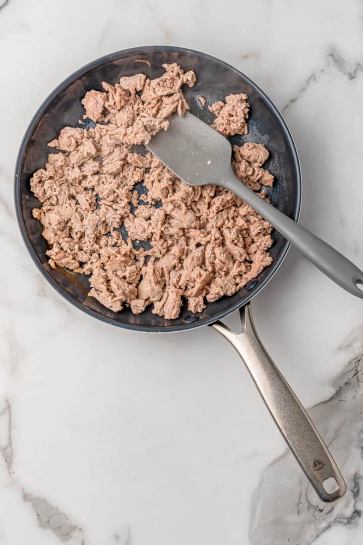 cooking ground turkey in a skillet.