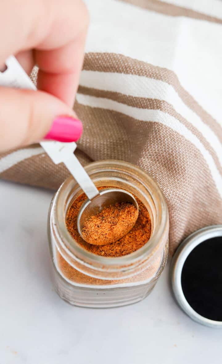 scooping seasoning out of the mason jar.