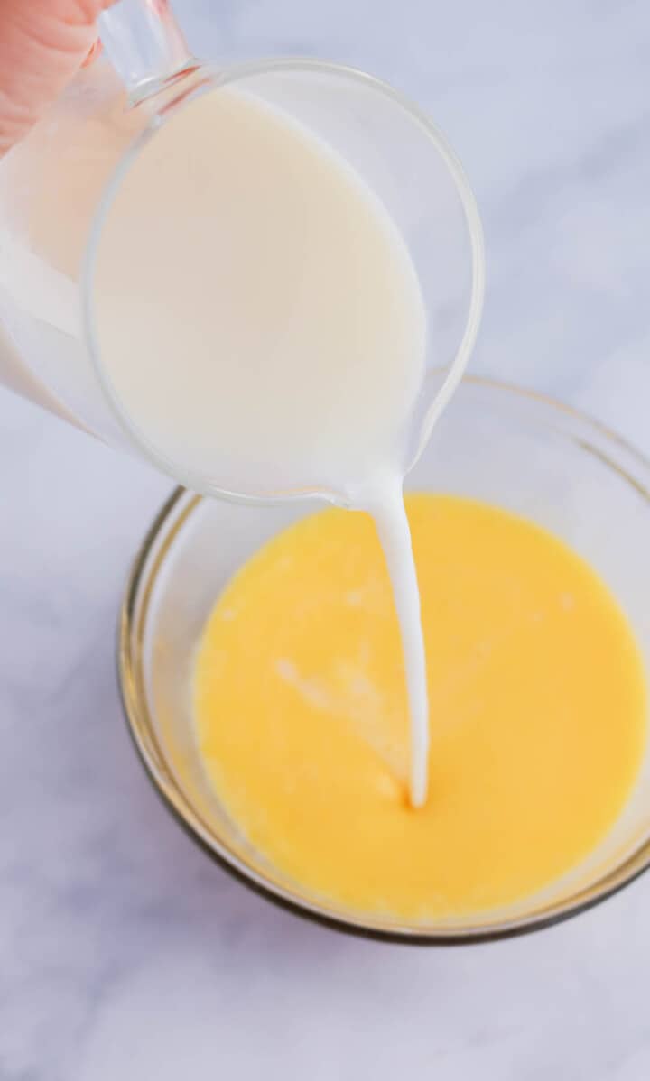 mixing together the milk and eggs.