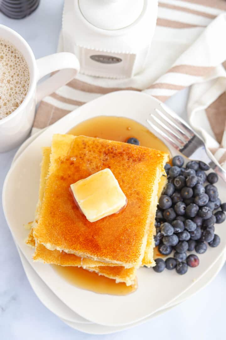top-down view of sheet pan pancakes on white plates.