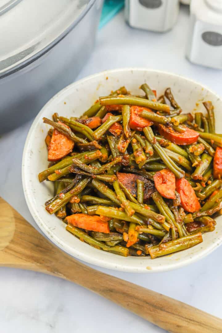 Southern Green Beans in white bowl with smoked sausage.