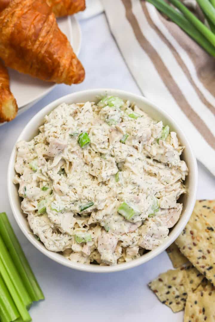 closeup of turkey salad in a white bowl.