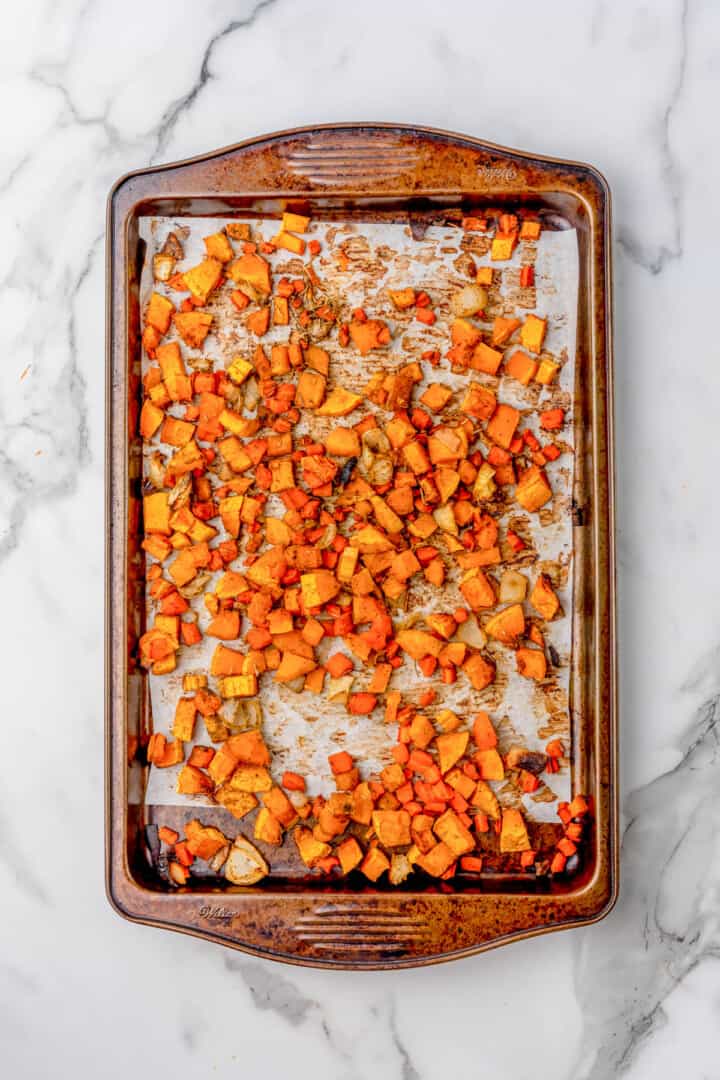 roasting the butternut squash and carrots on a baking sheet.