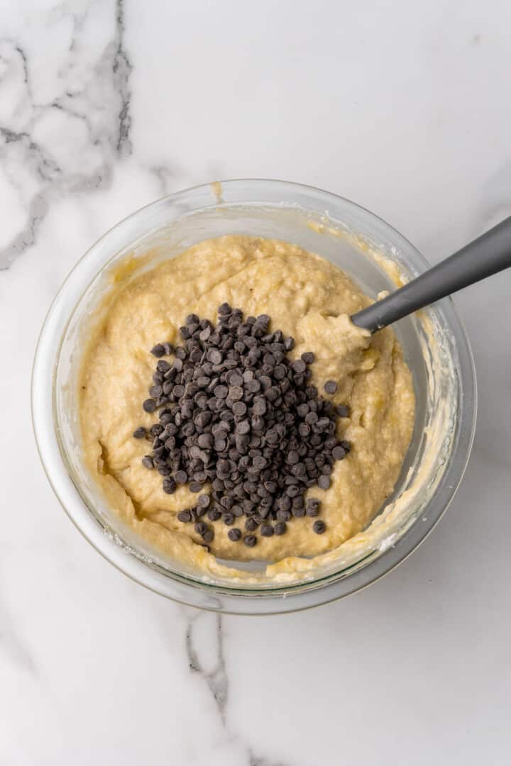 adding chocolate chips to the batter