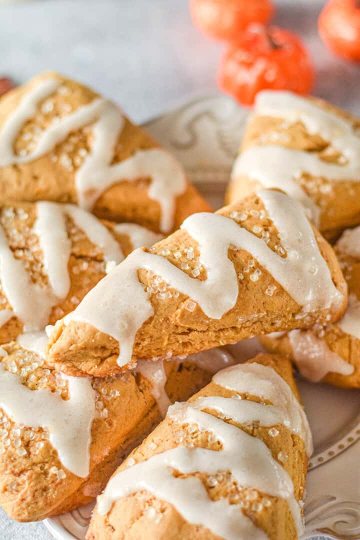 closeup of pumpkin scones topped with white icing.