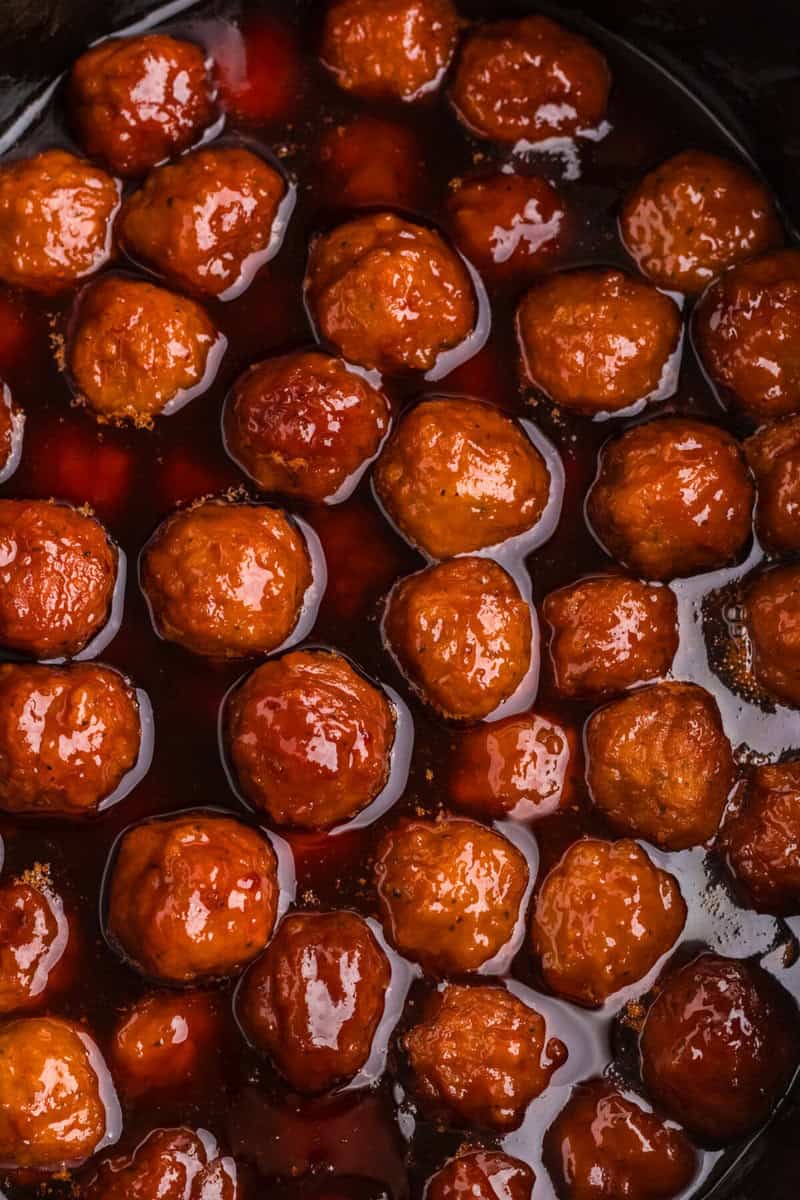 top-down view of the meatballs in the slow cooker.