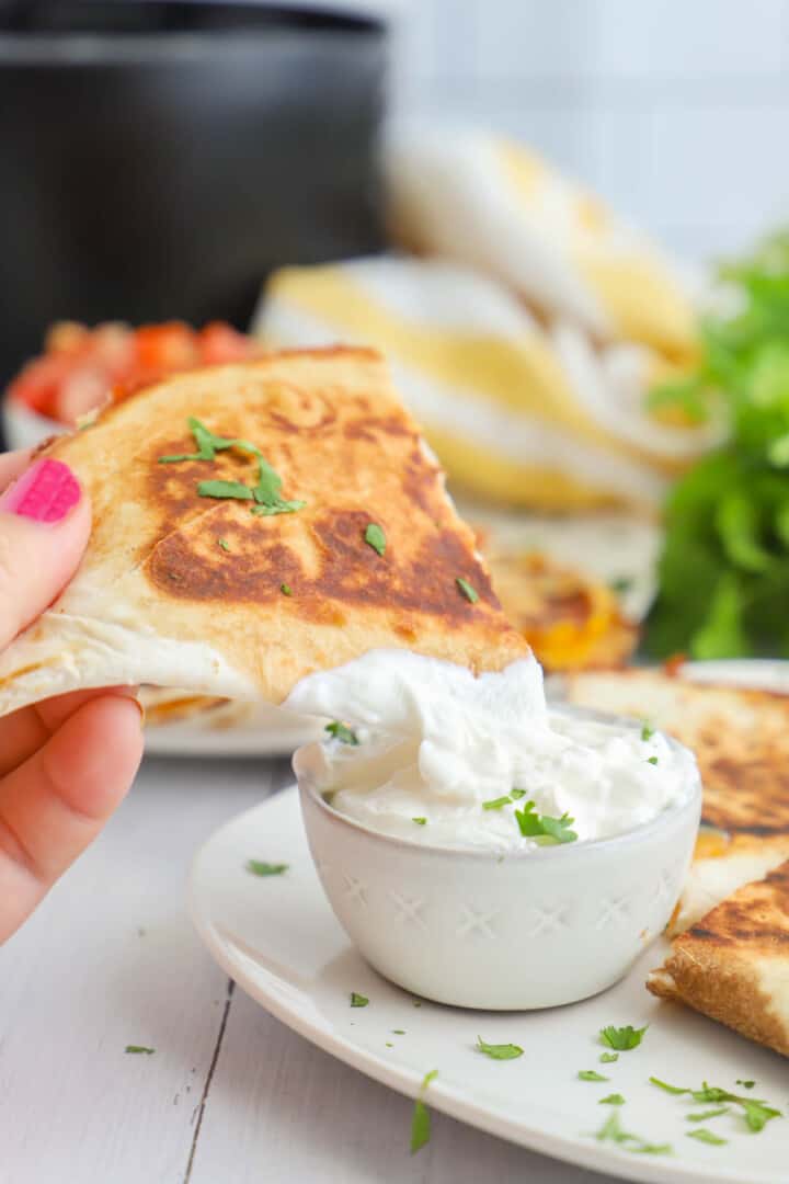 dipping quesadilla in sour cream.