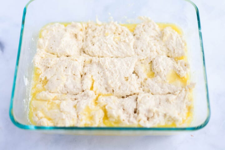adding the batter to the pan for the butter swim biscuits.