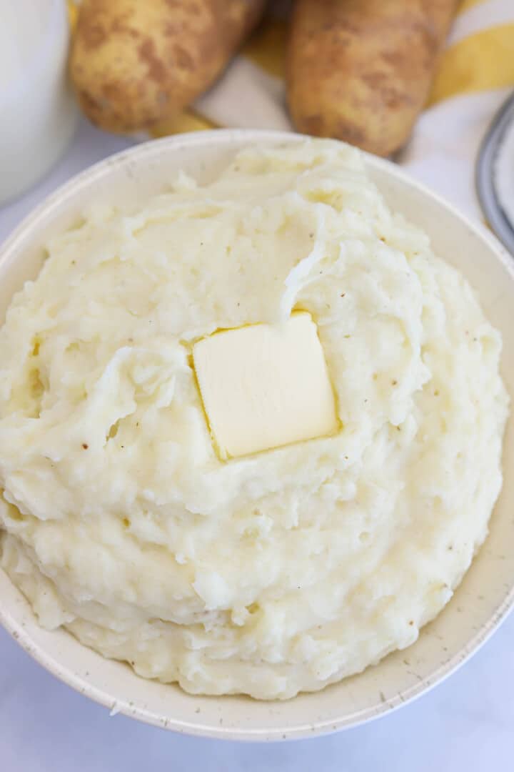 top view of buttermilk mashed potatoes with slap of butter on top.