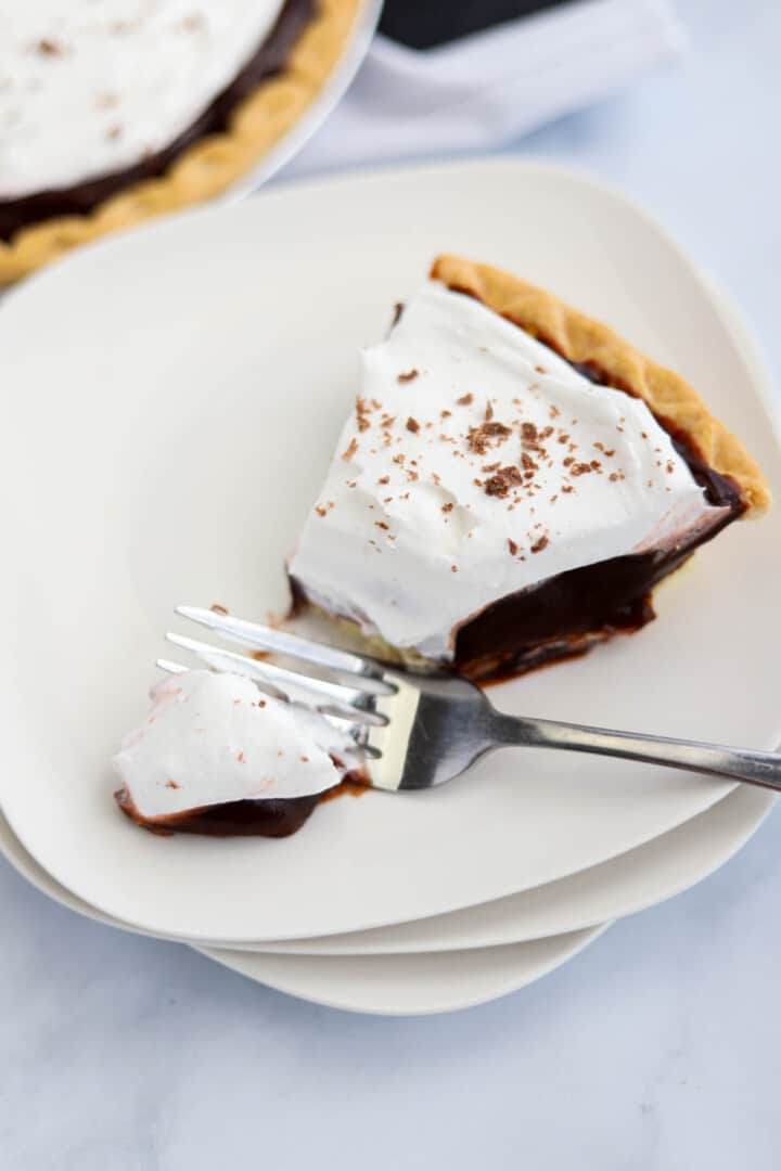 slice of chocolate pudding pie on white plate.