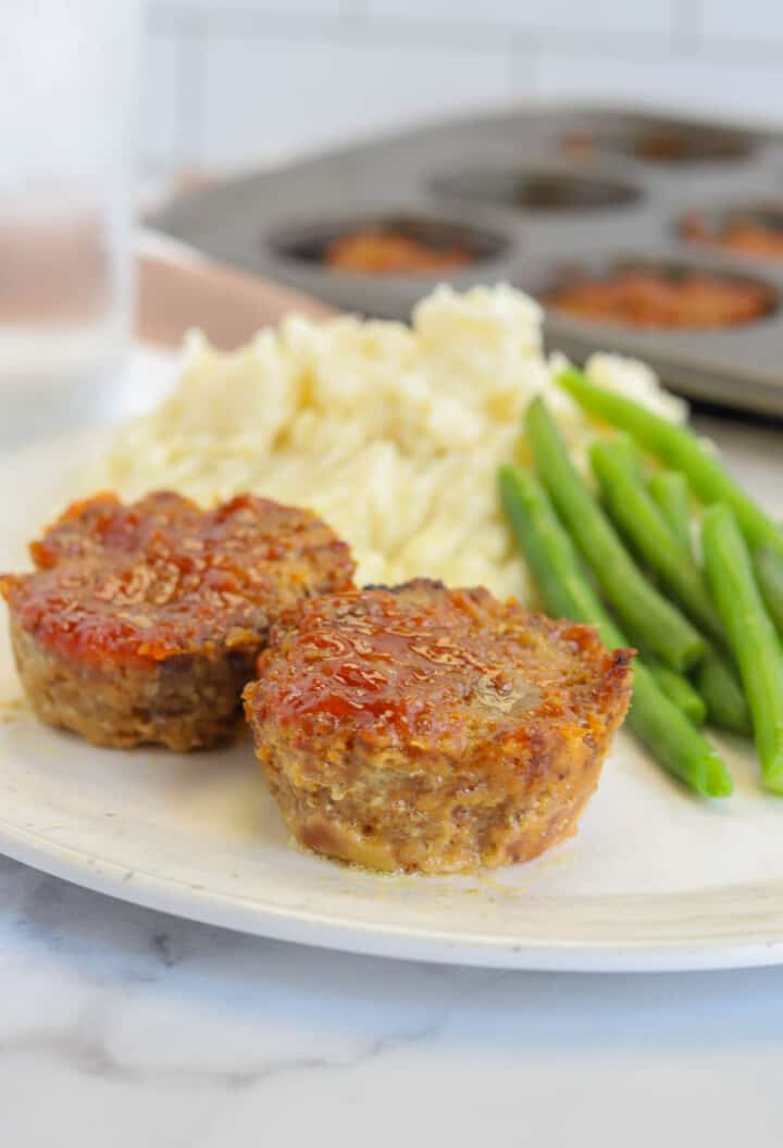 closeup of mini meatloaf on plate.