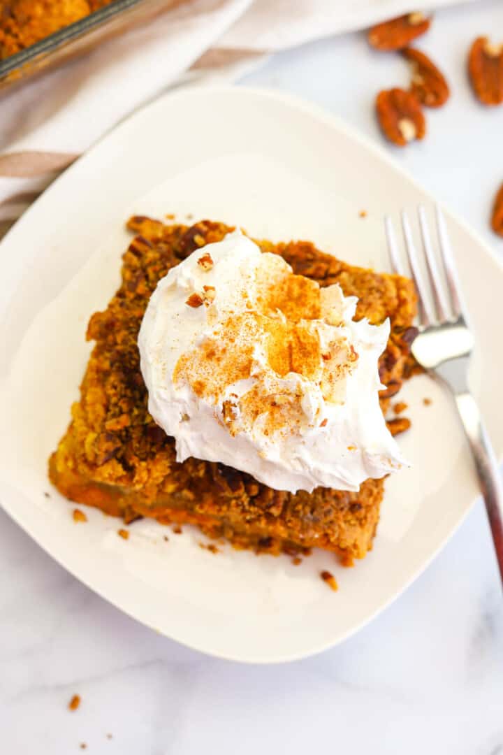 topview of pumpkin crunch cake on white plate.