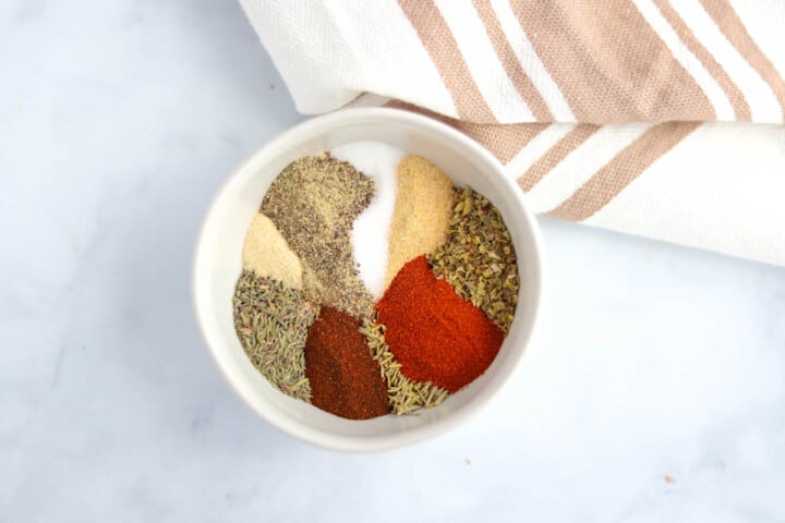 all spices for seasoning in a white bowl separated.