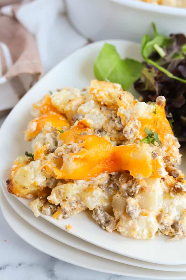 hamburger casserole served on plate with salad.