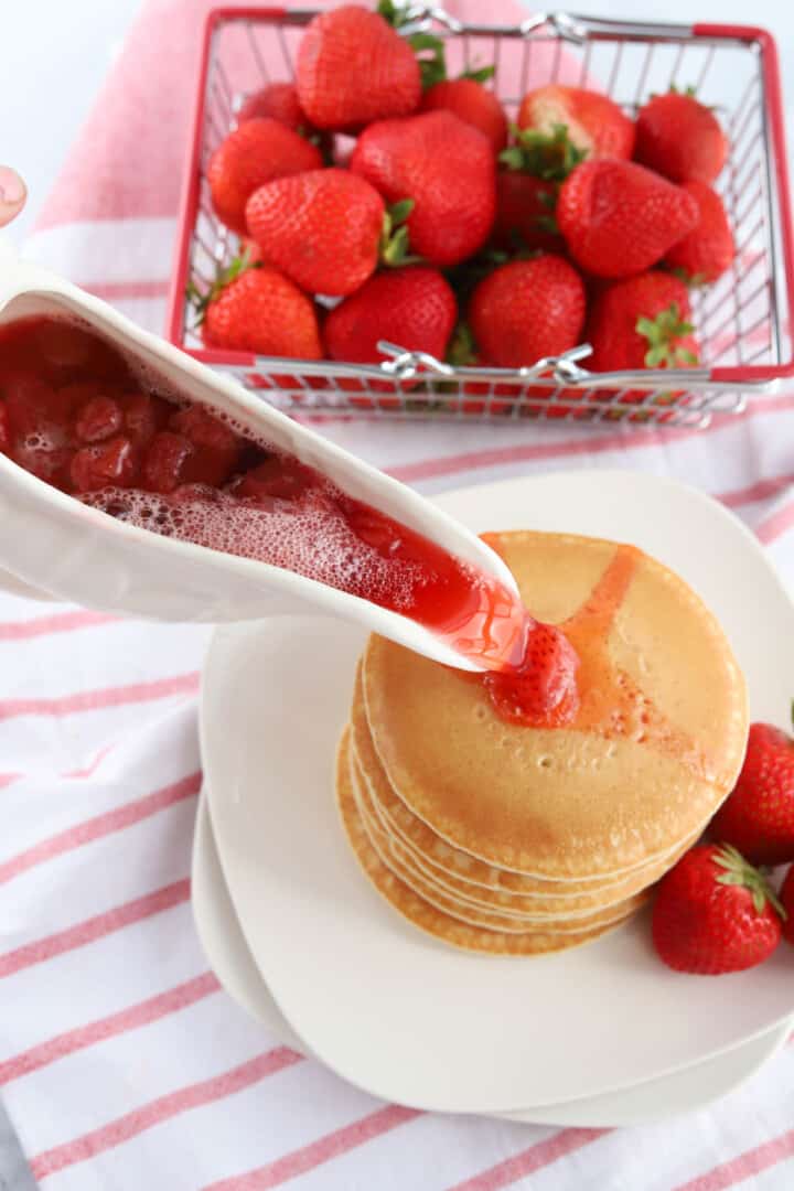 Strawberry Syrup poured over pancakes.