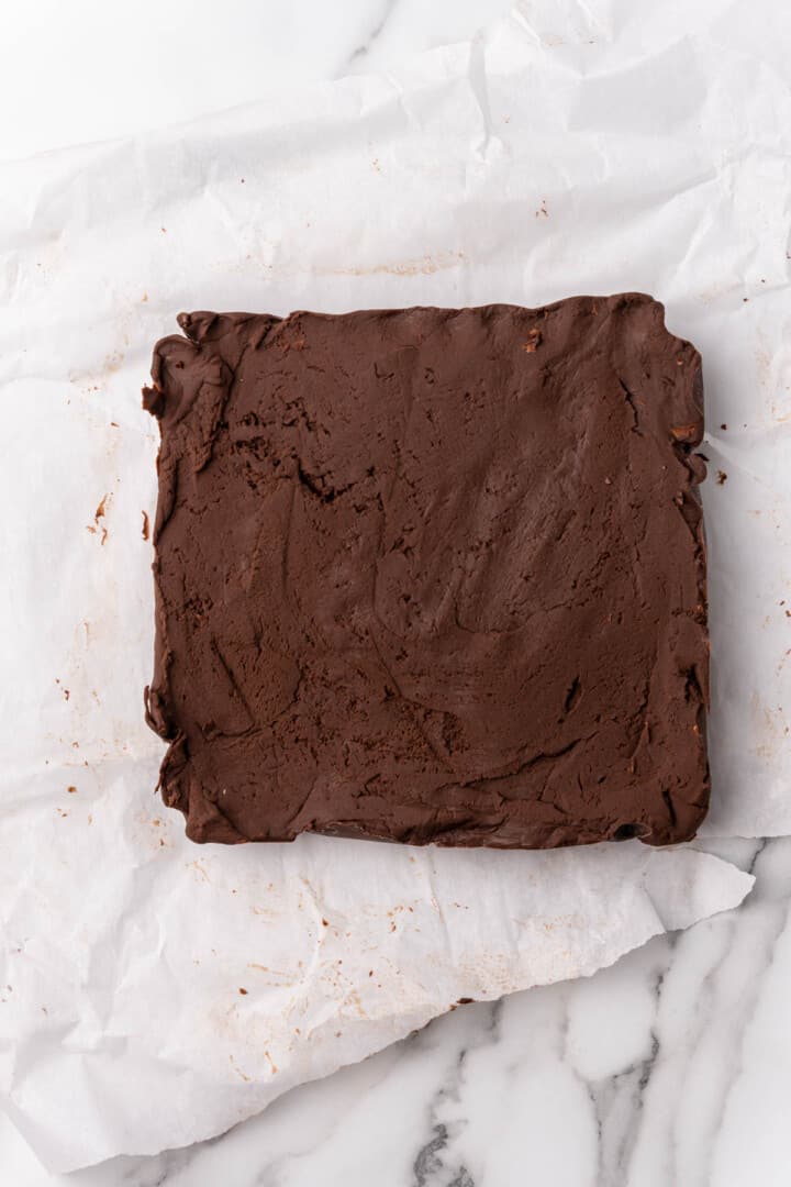 formed fudge bar on counter on parchment paper ready for slicing.