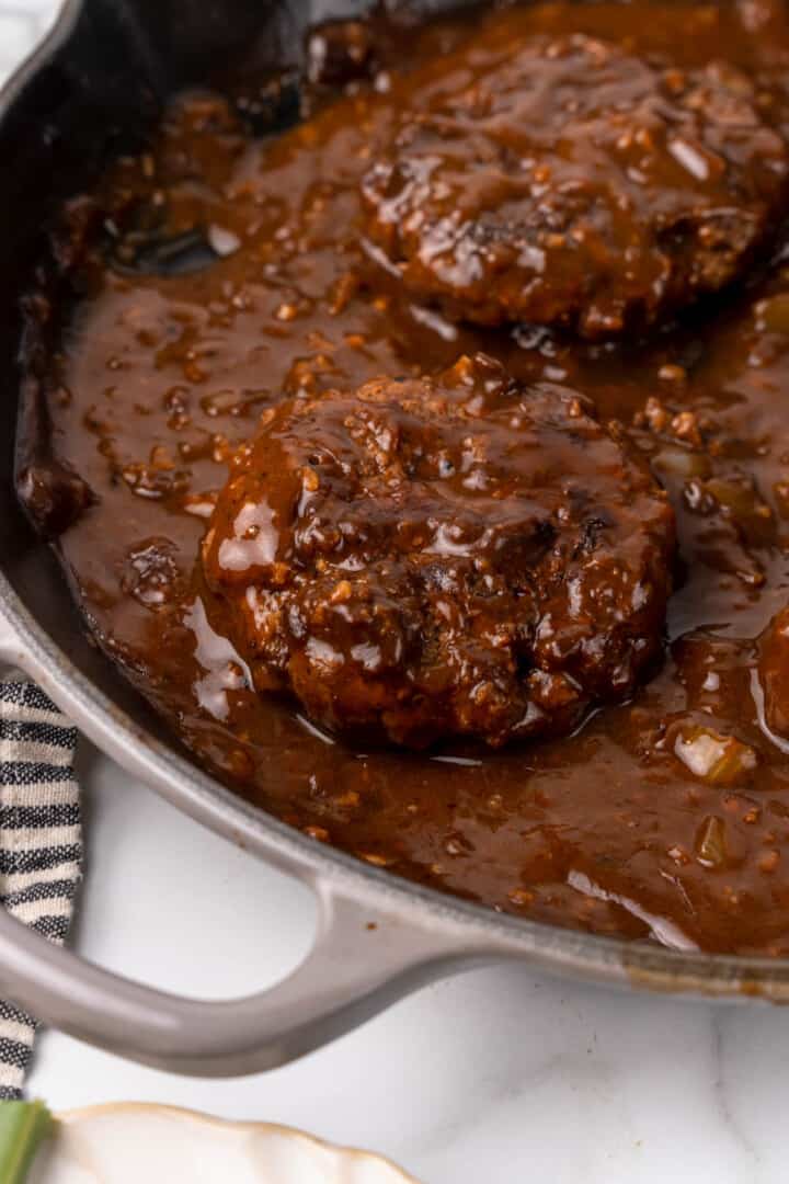 adding the steaks back to the gravy.