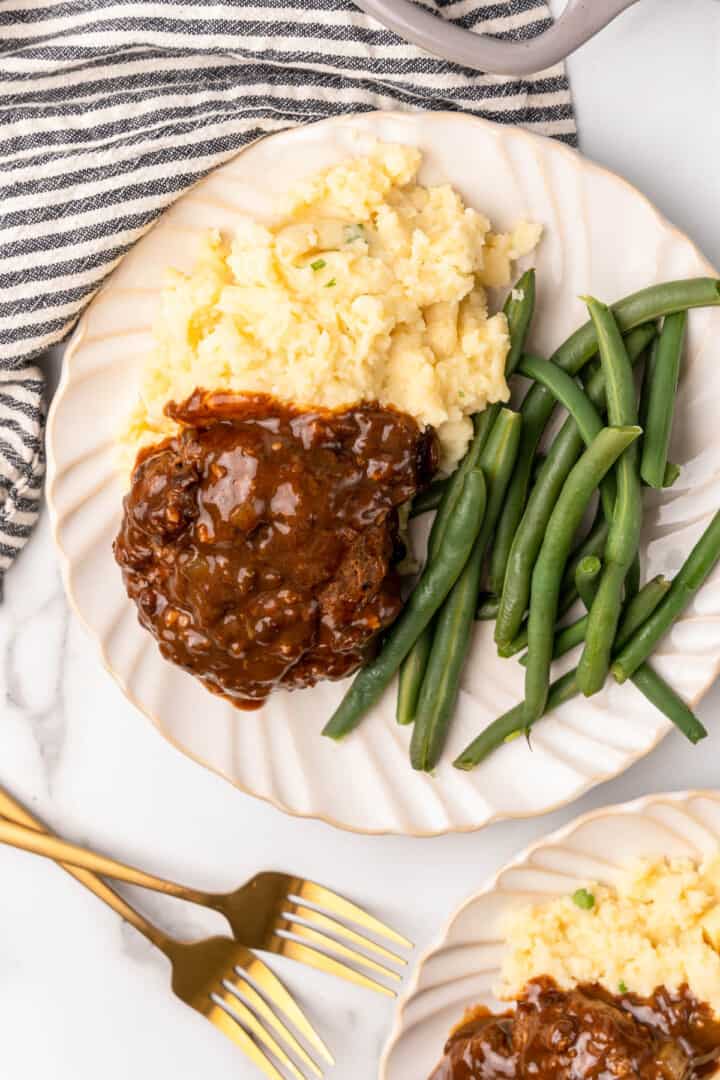 closeup of Salisbury steak with sides.