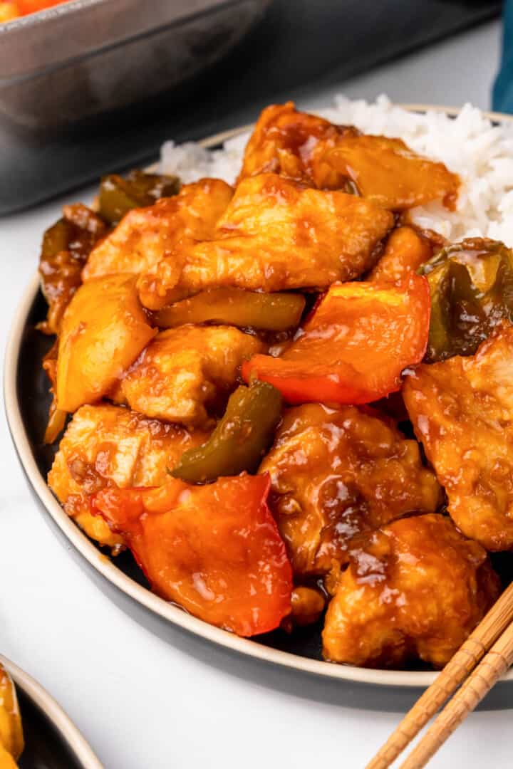 Sweet and Sour Chicken on plate with white rice.