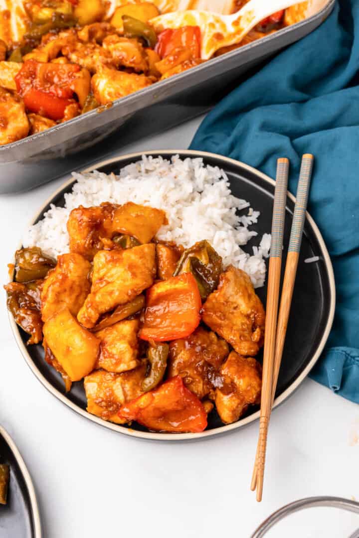 closeup of sweet and sour chicken on plate.