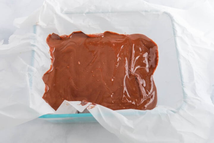 spreading fudge in parchment covered baking dish.