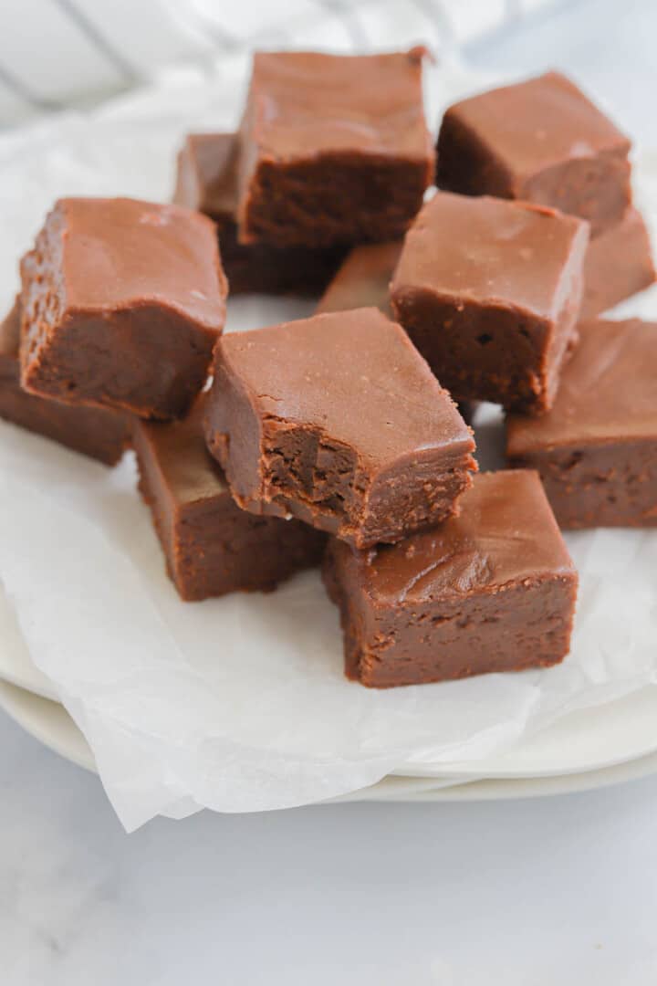 2 Ingredient Fudge stacked on parchment paper.