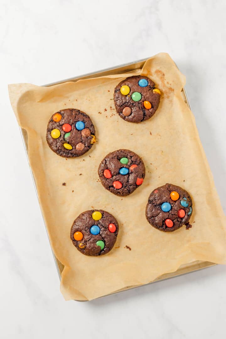 baked chocolate M7M cookies on baking sheet.