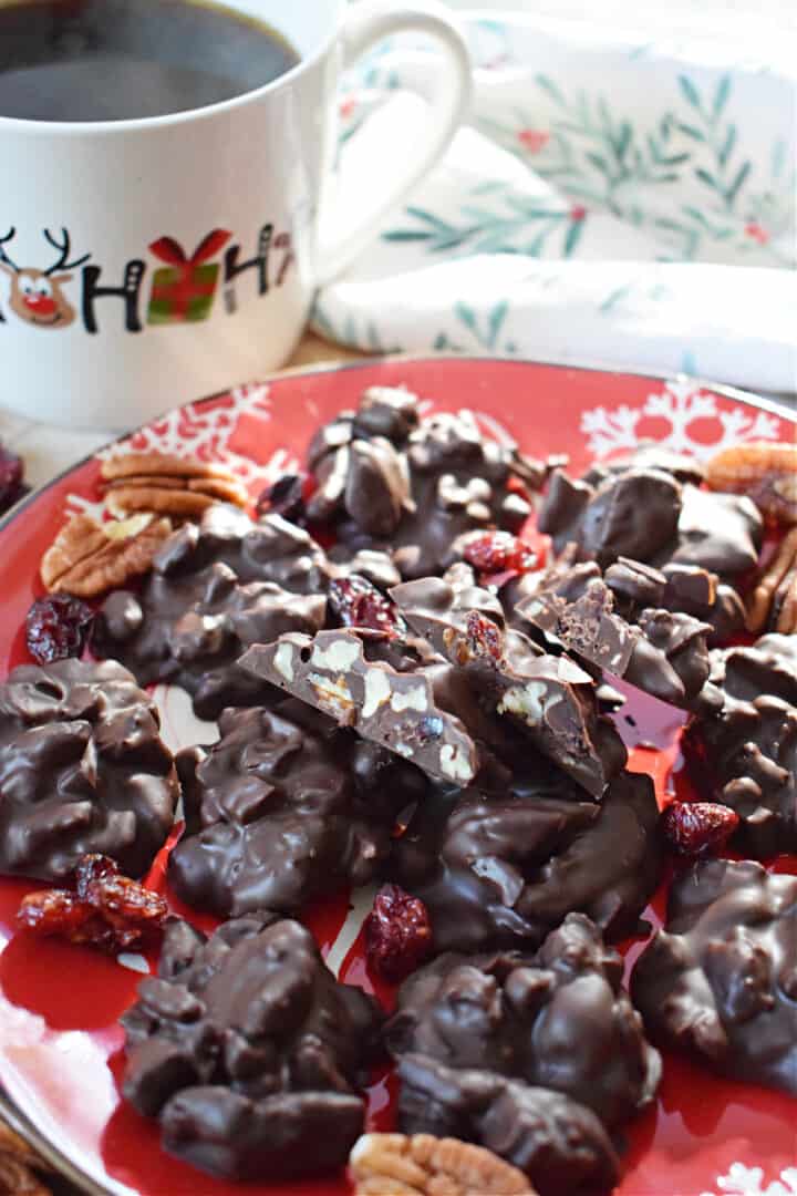Chocolate Pecan Cranberry Clusters on red holiday plate.
