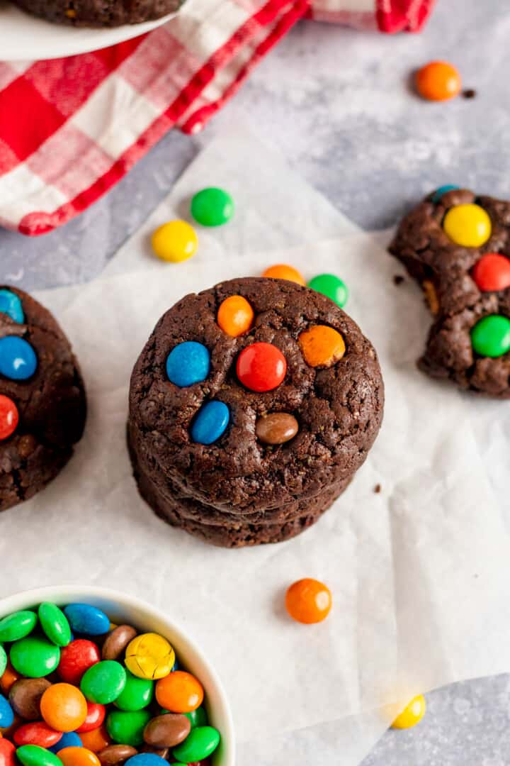 Chocolate M&M cookies stacked on top of each other.