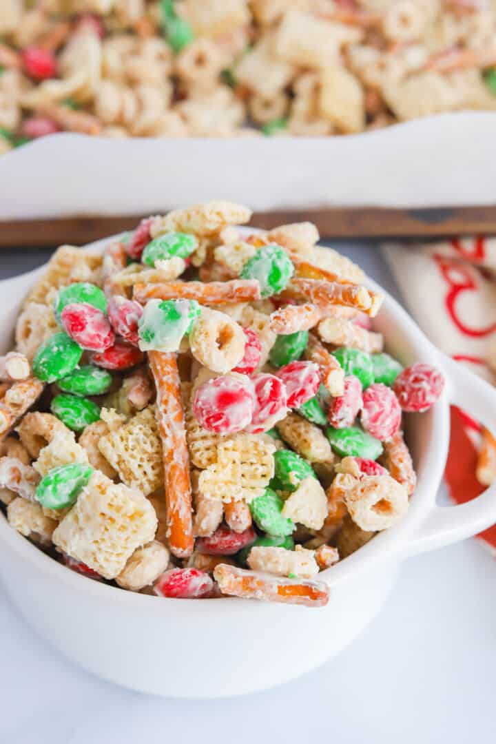 Christmas Chex Mix in white serving bowl.