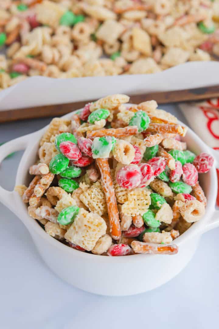 closeup of Christmas Chex Mix in white bowl.