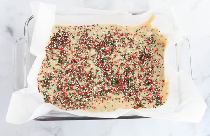 fudge in a baking pan lined with parchment paper.