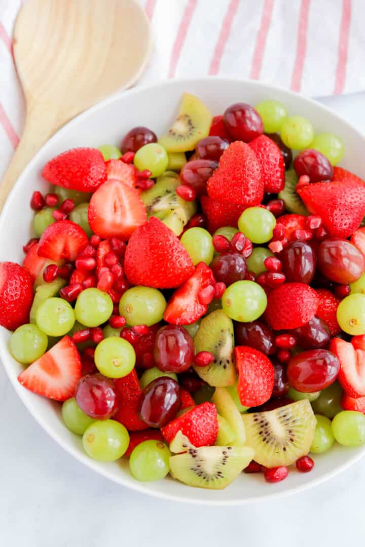 Christmas Fruit Salad in white serving bowl.