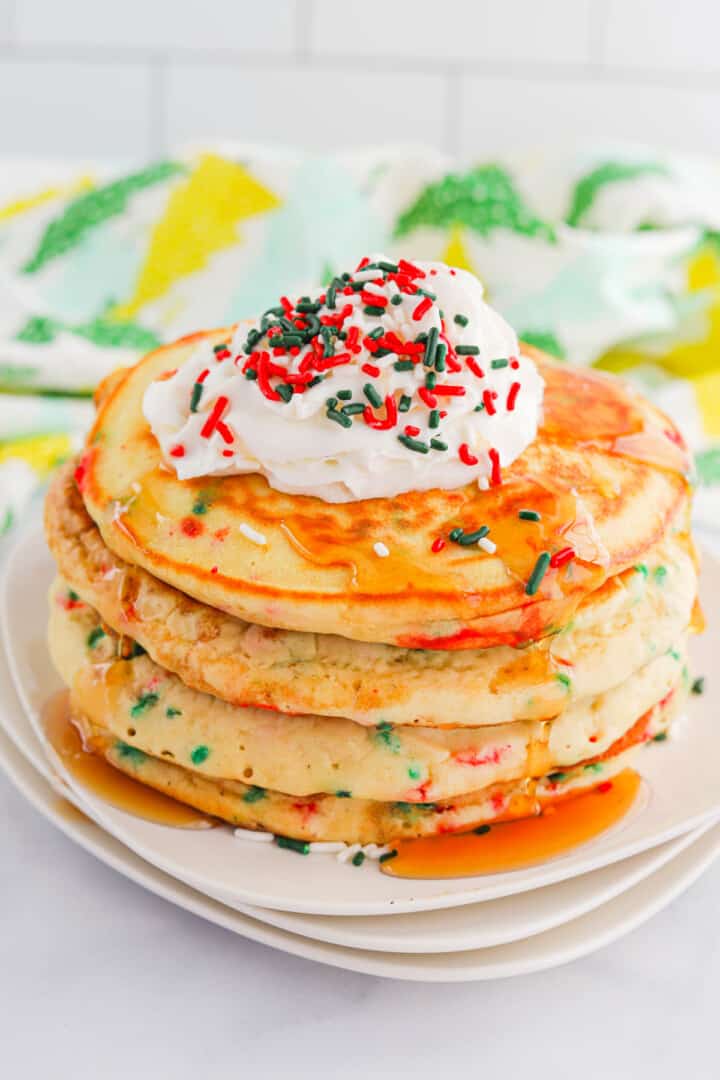 Christmas pancakes with syrup and whipped cream.