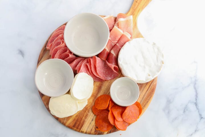 Adding the soft cheeses to the board.
