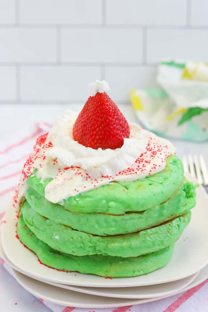 closeup of the pancakes stacked on a white plate.