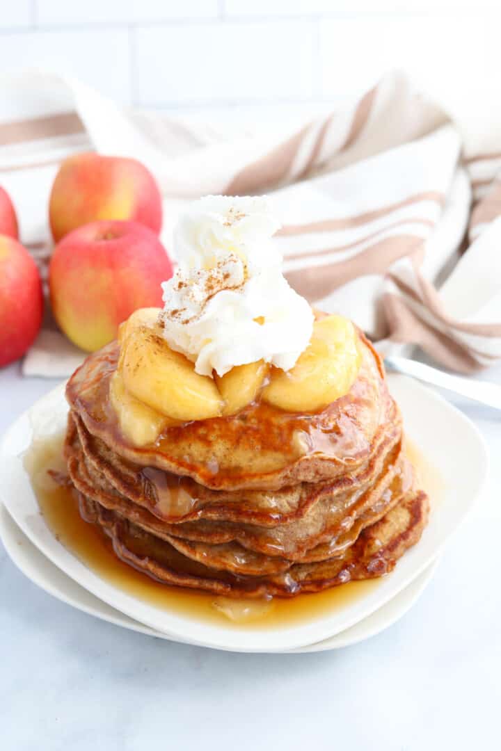 Apple Pie Pancakes stacked on white plate.