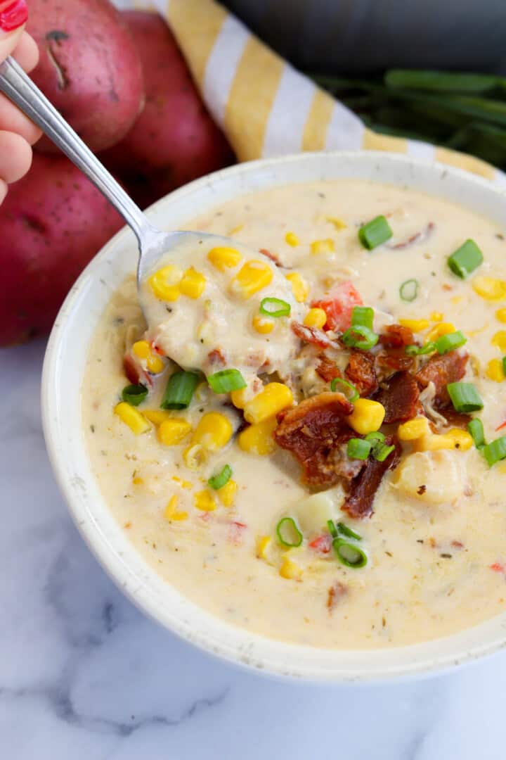 closeup of chicken corn chowder with spoon in the bowl.