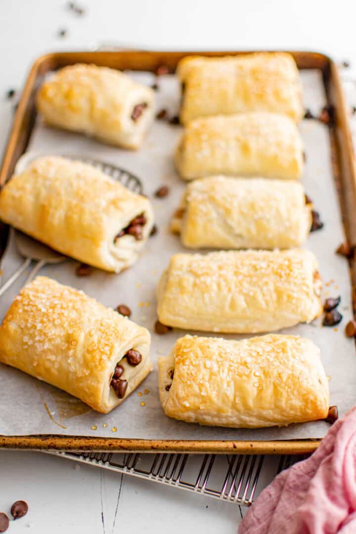 baked chocolate puff pastries on a baking sheet.