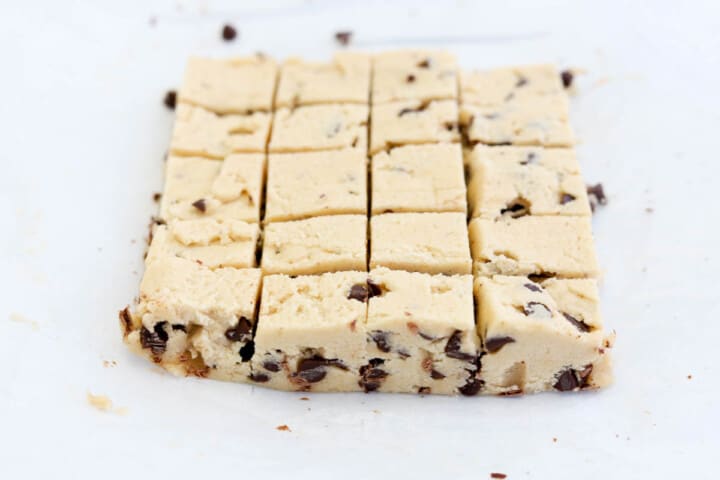 cutting the cookie dough into small squares to make the cookie dough balls.