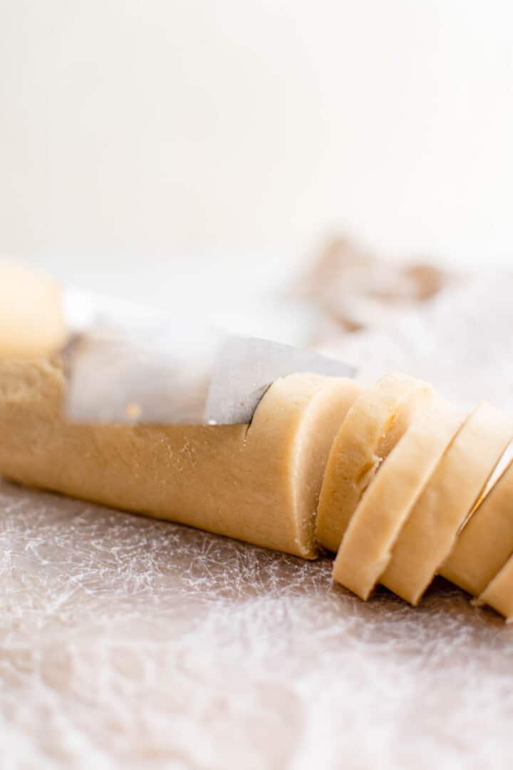 slicing the cookie dough before baking.