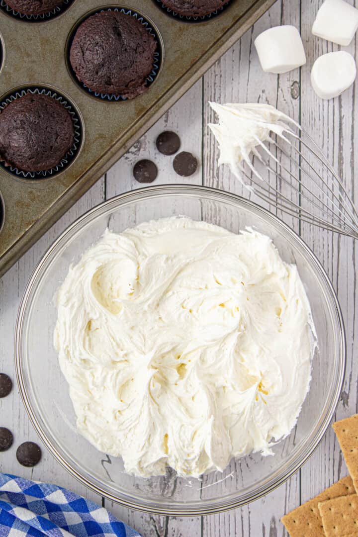 mixing the frosting with a whisk.