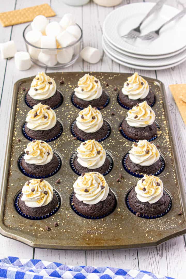 S'mores cupcakes frosting in cupcake pan.
