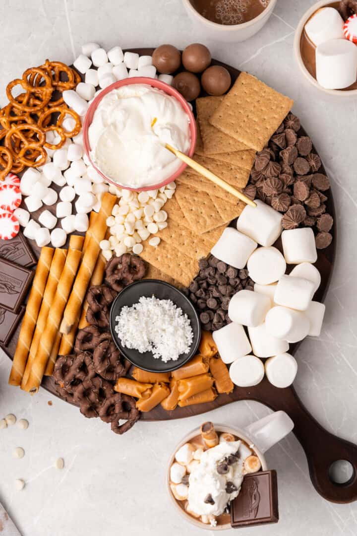 the hot chocolate bar set up with all the toppings and mugs of hot chocolate.