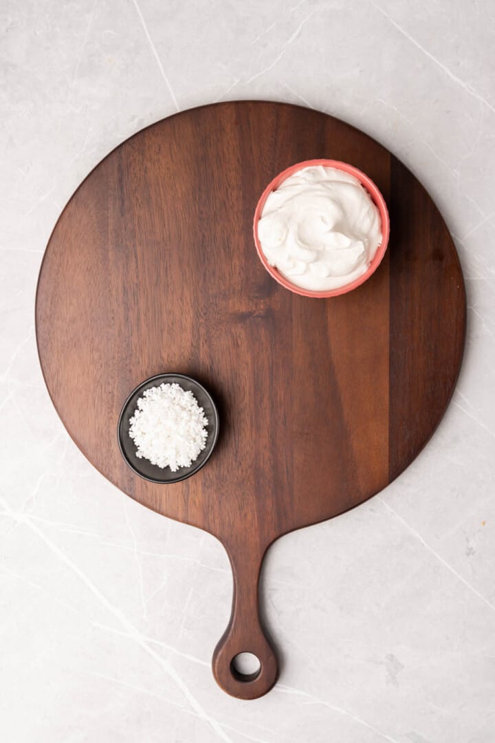 setting up the hot chocolate board with bowls of whipped cream and sprinkles.