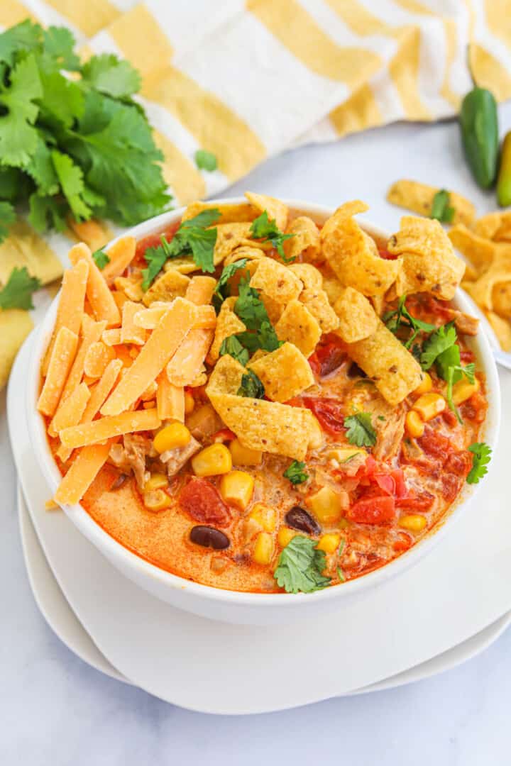 closeup of chicken tortilla soup in white bowl.