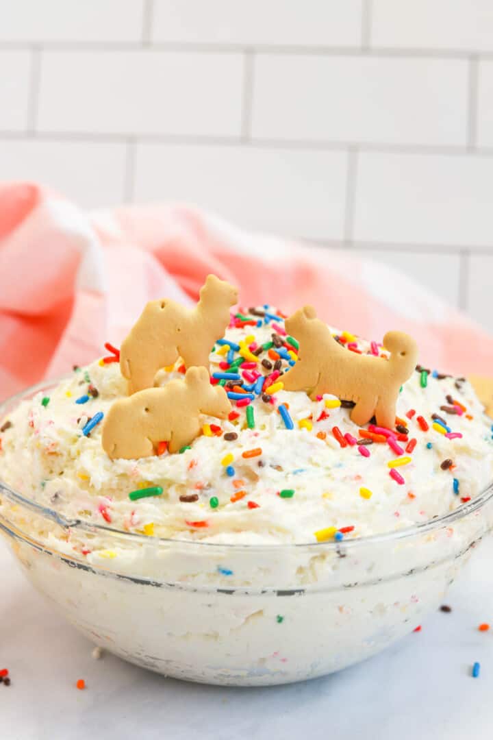 Funfetti Dip in clear bowl with animal crackers.