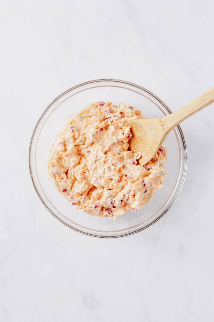 pimento cheese dip mixed together in glass bowl.