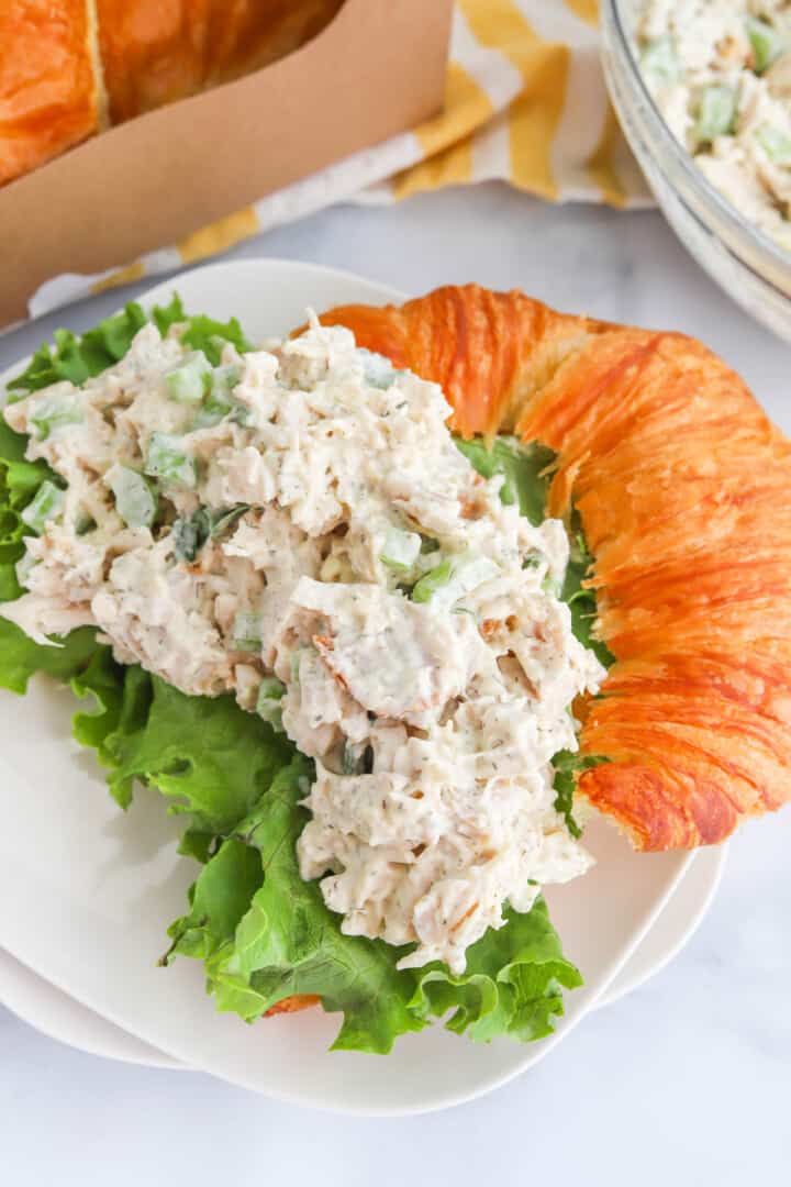 Rotisserie Chicken Salad on white plate served with croissant.