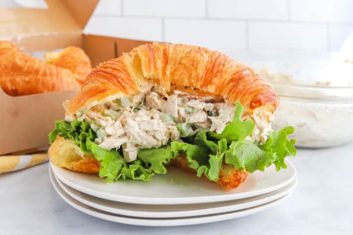 rotisserie chicken salad sandwich on white plate.